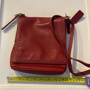Vintage red leather coach sling purse.  Magnetic closure.